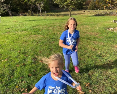 Two children, joyful in field.